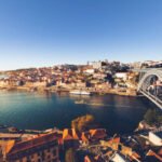 oporto city with douro river and dom luiz bridge under blue sky, portugal.